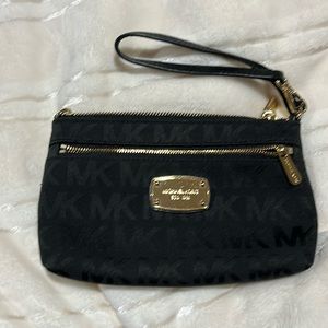 Michael Kors wristlet in black and gold. Near perfect condition.